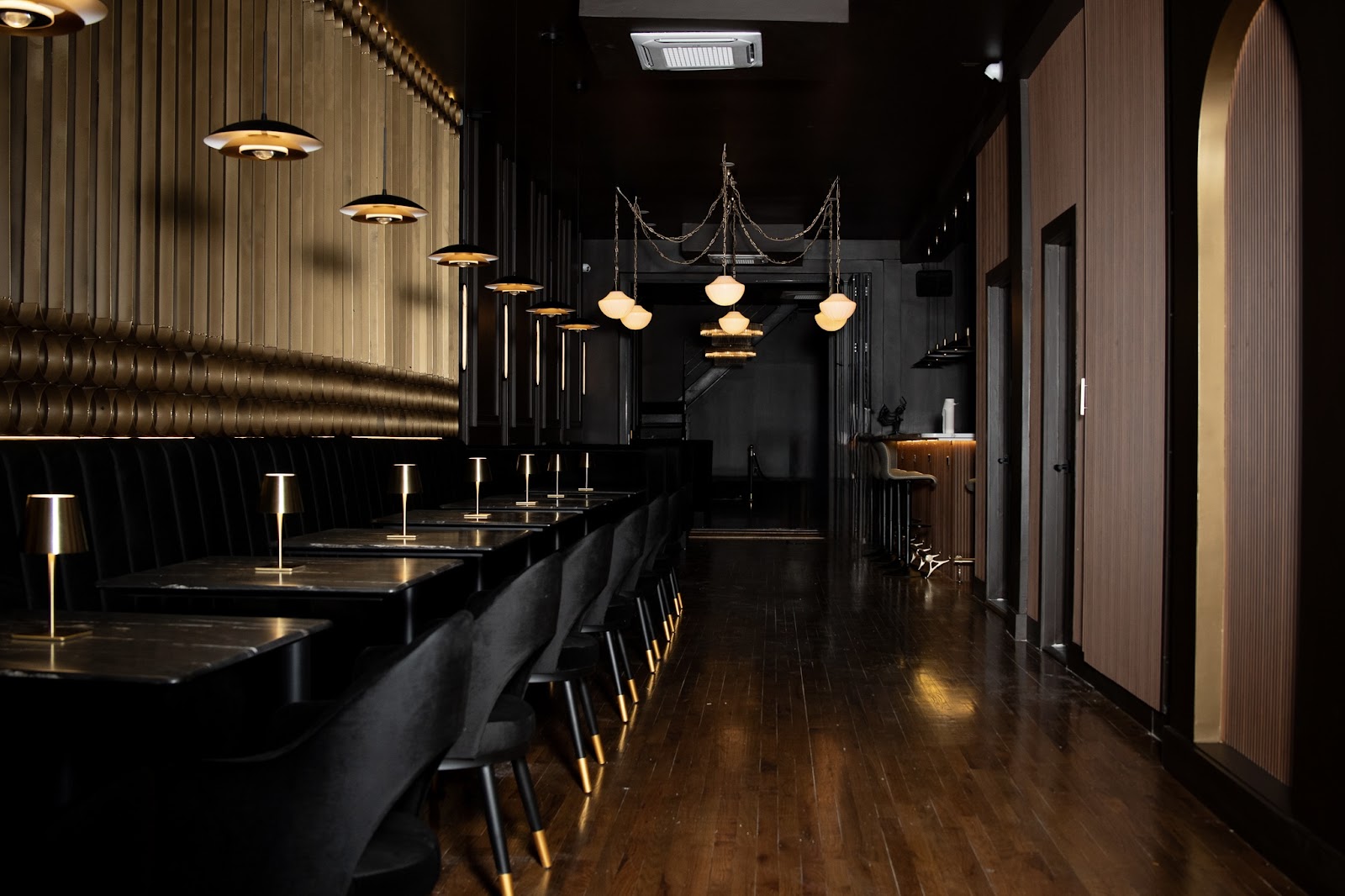 AURA dramatic interior with chandeliers and staircase